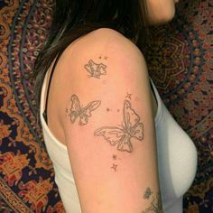 a woman with a butterfly tattoo on her arm