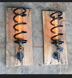 two wall sconces made out of wooden planks with light bulbs on them