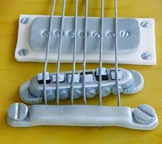 an electric guitar neck and bridge are shown