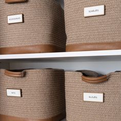 two baskets with labels on them are sitting on the shelves