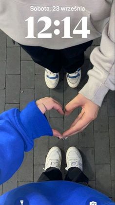 two people making a heart with their hands