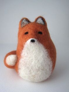 an orange and white stuffed animal sitting on top of a table