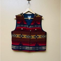 This Stunning Pendleton High Grade Western Wool Vest Is A True Vintage Treasure! Made From High-Quality Wool By Pendleton’s Woolen Mills, It Features A Vibrant Southwest Aztec Print That Captures The Essence Of Classic Western Style. Size 12 And In Excellent Condition, This Vest Is Perfect For Layering And Adding A Bold, Vintage Flair To Your Wardrobe. Size: 12 Color: Red With Southwest Aztec Print Material: High-Grade Wool Style: Western Vest Western Vest, Pendleton Jacket, Wool Vest, Aztec Print, Western Style, True Vintage, Western Fashion, Red Yellow, High Grade