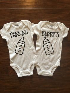 two baby onesuits that say drinking buddies and one with a bottle on it