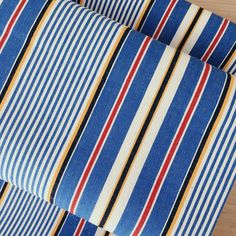 a blue and red striped tie laying on top of a wooden floor