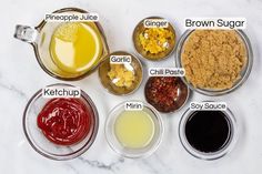 an assortment of ingredients are shown in bowls on a marble countertop, labeled with the names of different sauces