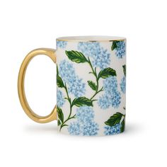 a blue and white coffee mug with flowers on it