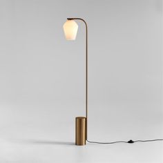 a floor lamp with a white light on it