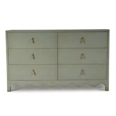 a white dresser with four drawers and two knobs on each drawer, in front of a white background