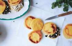 some food that is on top of a white plate next to a knife and fork