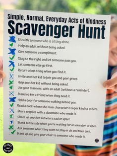 a person holding up a sign that says scavenger hunt in front of them