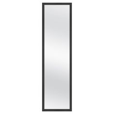 a tall mirror sitting on top of a white wall next to a black cabinet and door