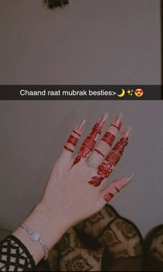 a woman's hand with red and white henna on it, next to the words chand raat murbak besties