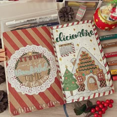 an open notebook with christmas decorations and writing on the cover, surrounded by other items