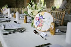 the table is set with flowers and place settings for an elegant wedding breakfast or brunch