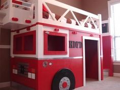 a red and white fire truck bunk bed with ladders on the top, built into the wall