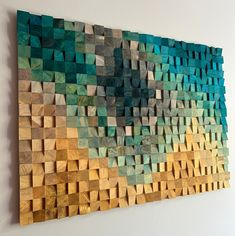 a painting made out of wood blocks on the wall