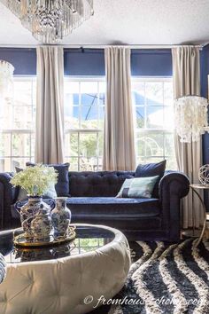 a living room filled with furniture and a chandelier