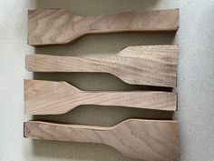 three wooden utensils sitting on top of a counter