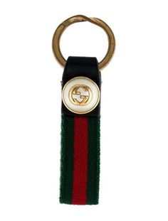 a keychain with a gucci logo on the front and green, red, and black stripes