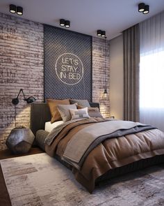 a bedroom with brick walls and a large bed in the center, along with two lamps on either side of the headboard