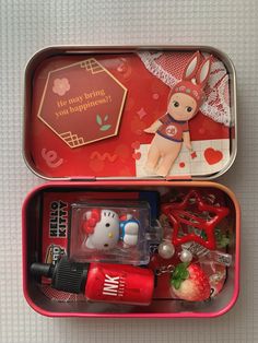 two tins filled with different items on top of a table