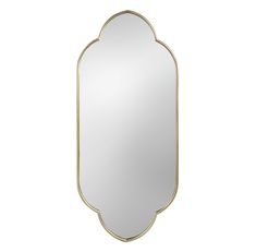 a gold framed mirror on a white wall