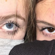 two women with blue eyes are covering their faces