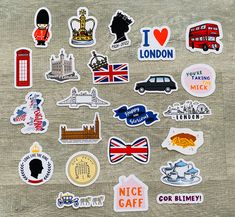 many different stickers on a wooden surface with the words london and british symbols in them