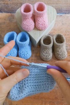 someone is crocheting baby booties on the table