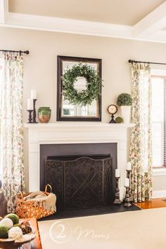 a living room filled with furniture and a fire place in front of a mirror on the wall