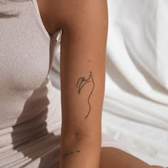 a woman with a small tattoo on her arm