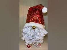 a white and red sequined santa clause hat on top of a stuffed animal