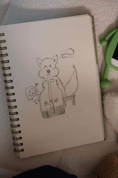 an open notebook with a drawing of a fox on it