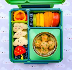 a bento box filled with fruit, vegetables and meatballs for kids to eat