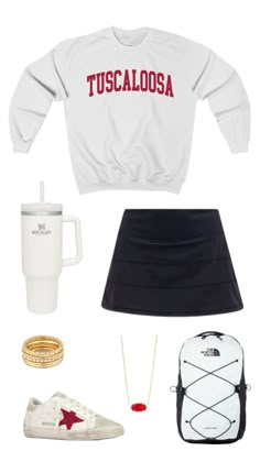 a white sweater and black skirt with red lettering on the front, two coffee mugs,