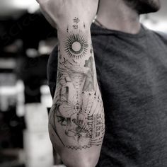 a man is holding his hand up to his face while he has a tattoo on his arm