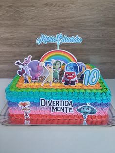 a birthday cake decorated with cartoon characters on it