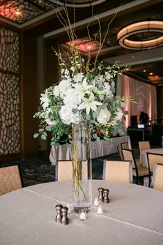 a vase filled with white flowers on top of a table