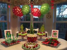 a table set up for christmas with balloons and decorations