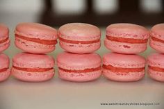 several pink macaroons stacked on top of each other