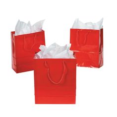 three red bags with white tissue paper on them, one has a handle and the other is