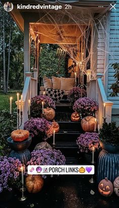 an outdoor porch decorated for halloween with pumpkins and flowers on the steps, surrounded by candles