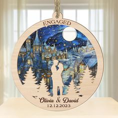 a wooden ornament with an image of a couple kissing in front of a castle