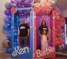 three people standing in front of a backdrop with balloons