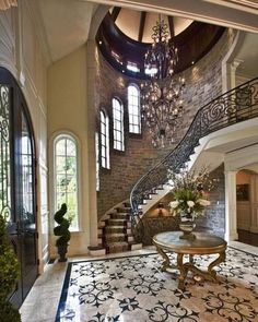 an elegant foyer with chandelier and stairs leading up to the second floor area