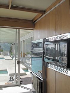 the inside of a house with an open patio and swimming pool