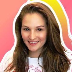 a woman with long brown hair wearing a white shirt and smiling at the camera while standing in front of a pink background