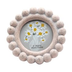 a white frame with yellow and white flowers in the shape of a flower pot on it