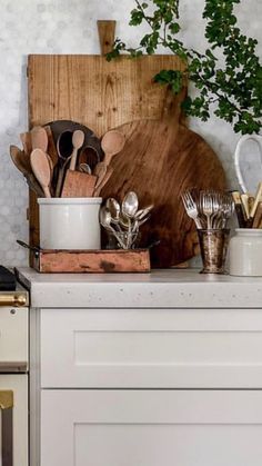 an image of kitchen utensils displayed on the counter in front of a wooden cutting board